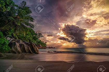 Sunset behind a cloud on the beach
